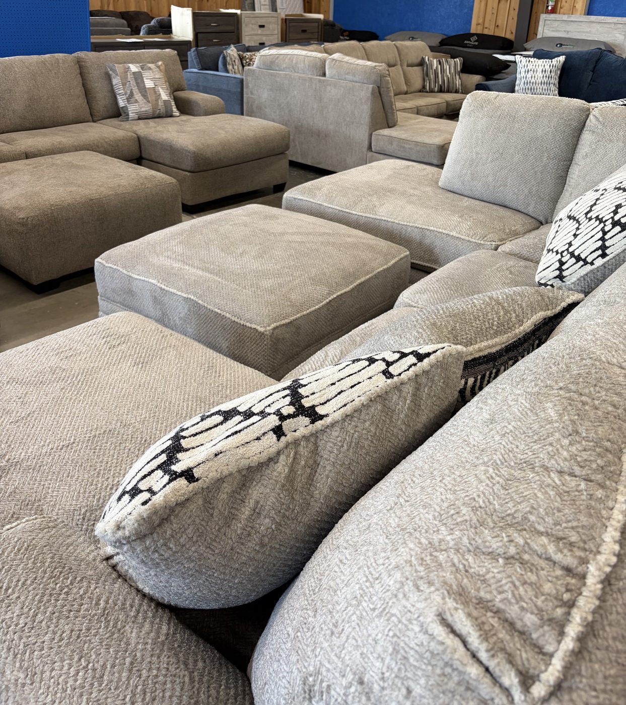 Textured sectionals and ottomans on the showroom floor